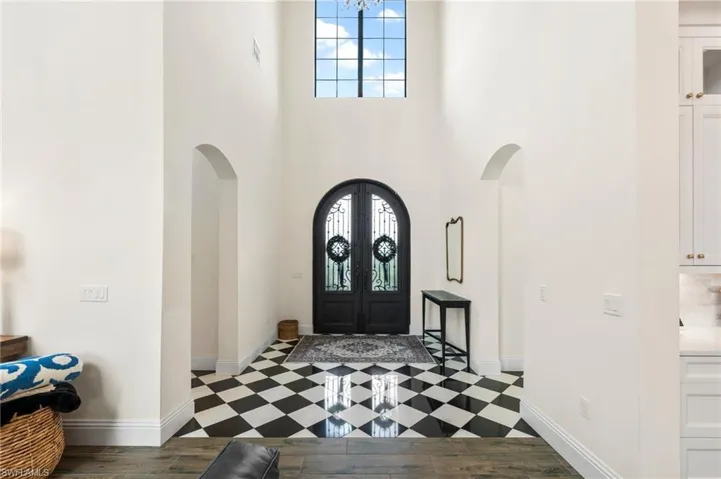 Formal Two Story Foyer with Custom Iron Front Doors.