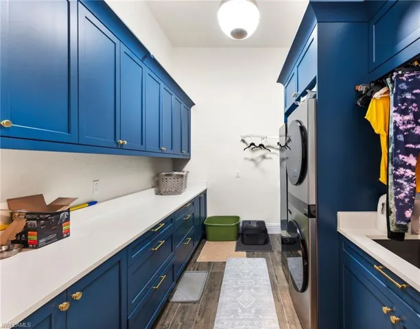 Amazing laundry rm with state of the art Steam Closet, lots of cabinets & counter space and high end washer/dryer