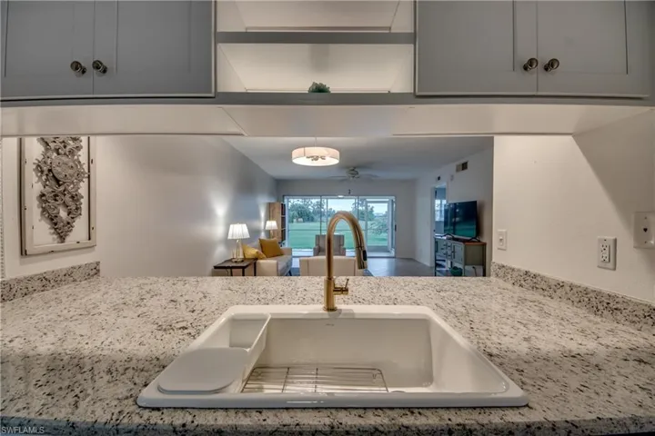 Kitchen with white cabinetry, white appliances, and decorative backsplash