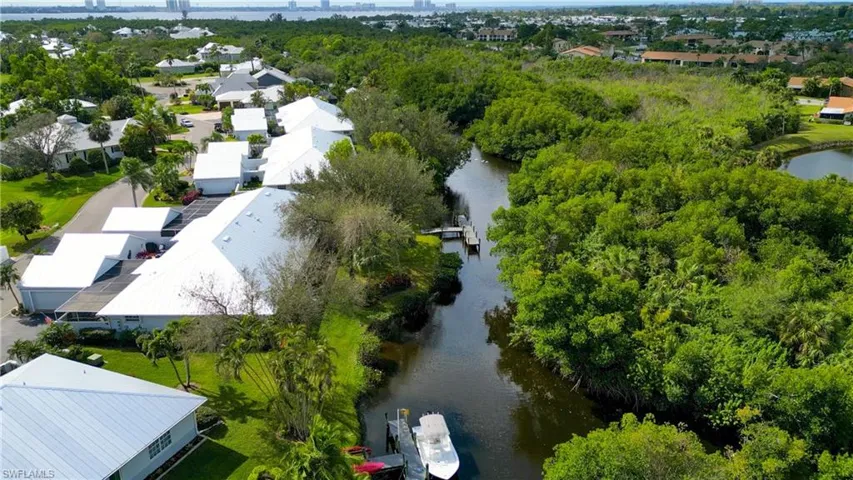 Birds eye view of property with a water view