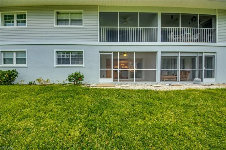 Rear view of property featuring a lawn