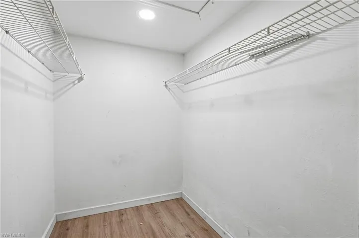 Spacious closet with light wood-style floors