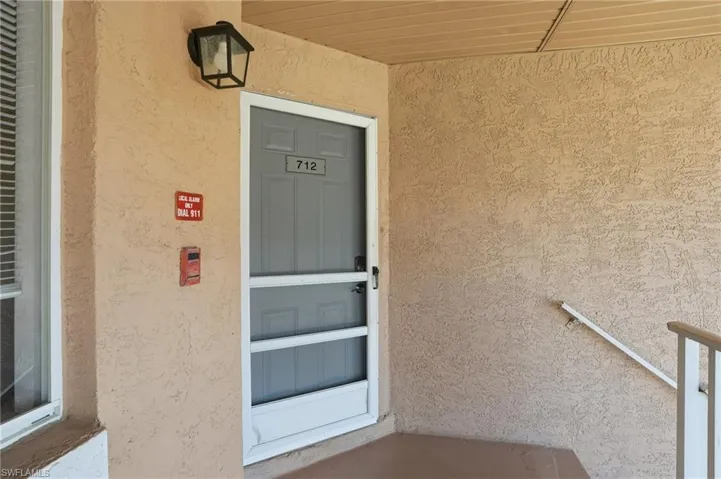 Entrance to property featuring stucco siding