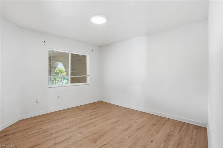 Unfurnished room with light wood-type flooring