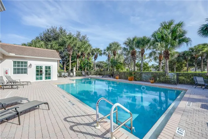 Community pool featuring french doors and a patio area