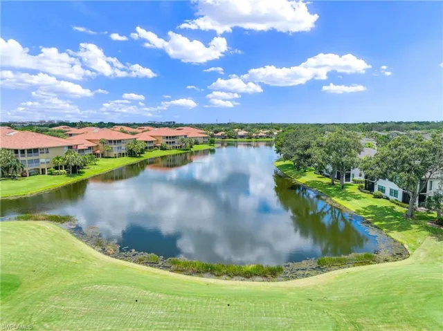 Water view with a golf club and nearby suburban area
