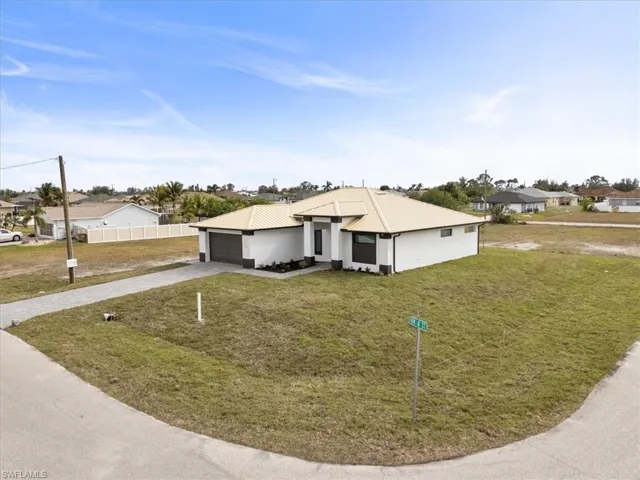 Single story home with a front yard and a garage
