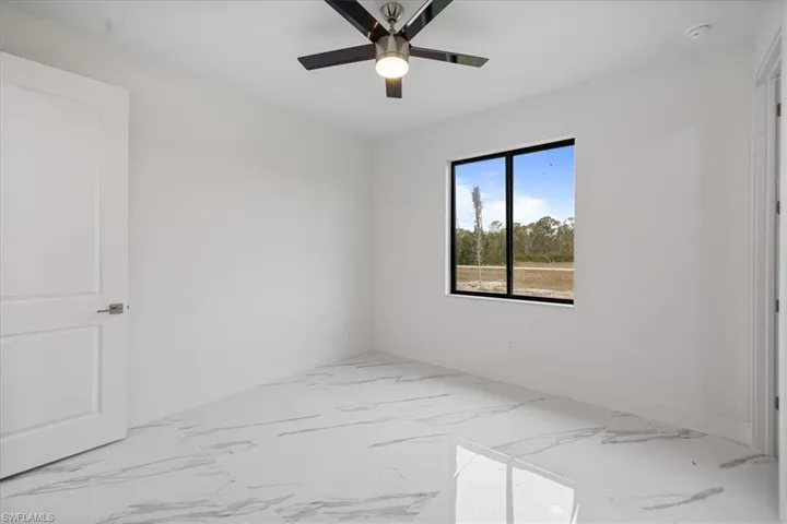 Spare room with ceiling fan