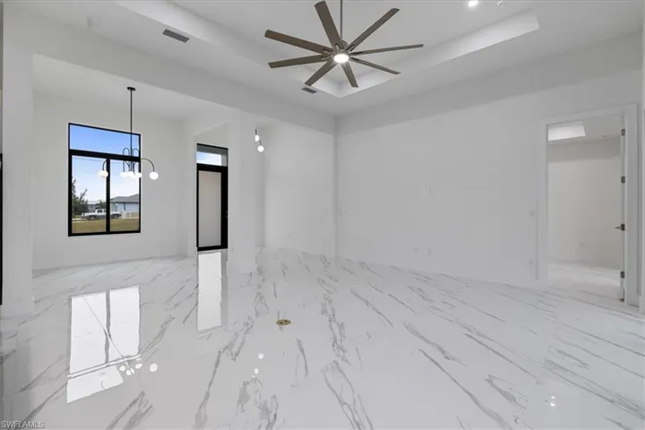 Spare room with ceiling fan and a raised ceiling