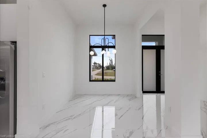Dining area with french doors and an inviting chandelier