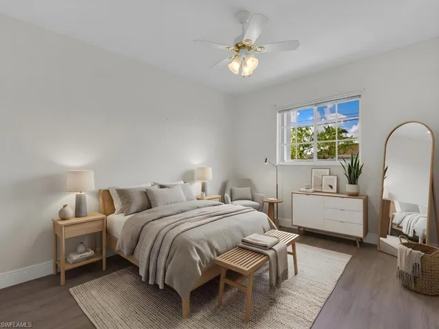 Bright room with wood-finish flooring, a ceiling fan with integrated lighting, and a prominent window