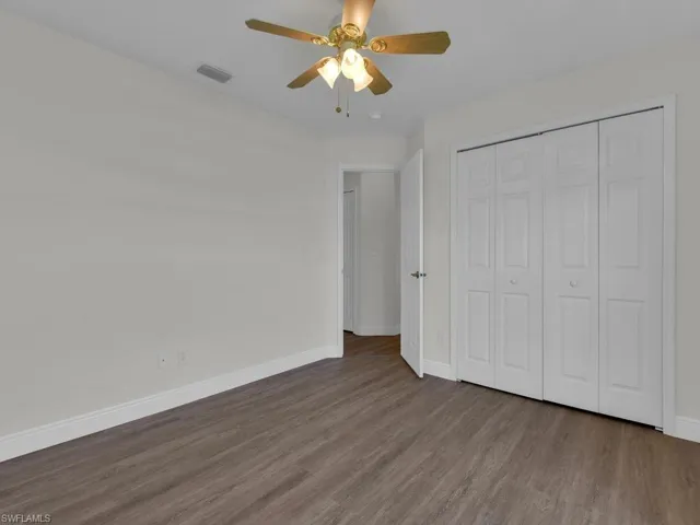 Room featuring wood-finish flooring and white baseboards