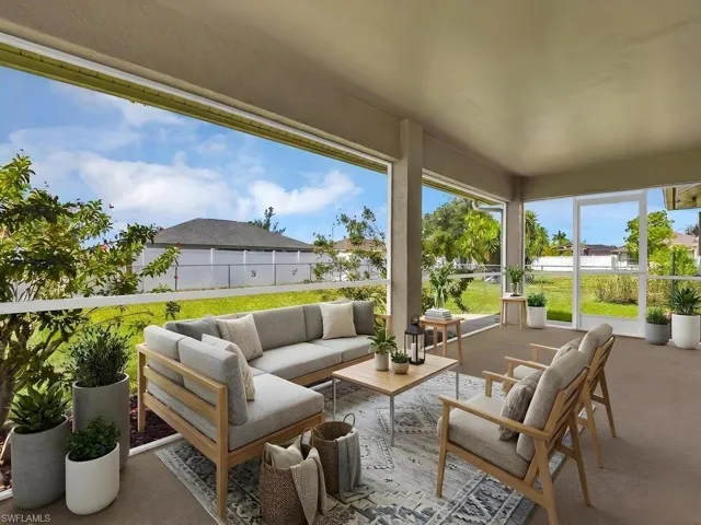 Screened lanai featuring a flat ceiling, concrete flooring, and a clear exterior fence