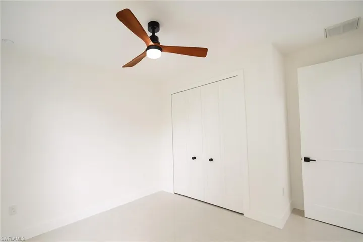 Unfurnished bedroom featuring ceiling fan and a closet