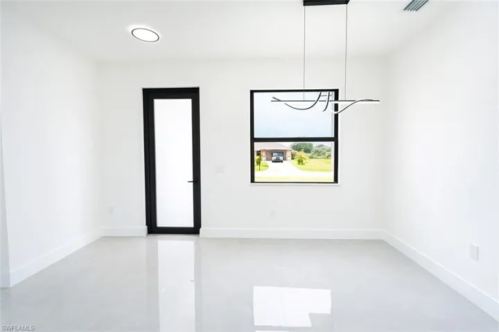 Unfurnished room featuring baseboards