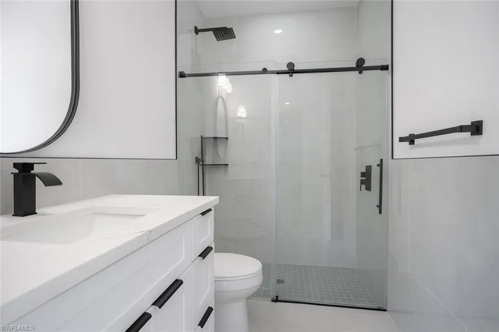 Bathroom featuring vanity and a shower stall