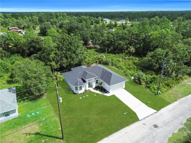 View of subject property featuring a heavily wooded area