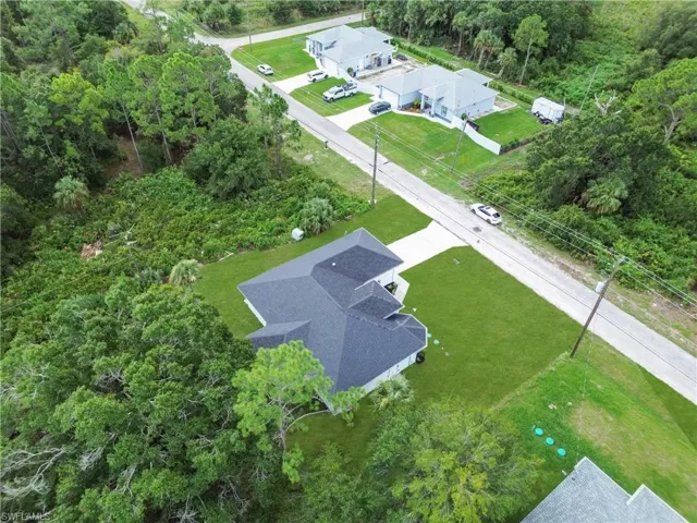View from above of property featuring a tree filled landscape