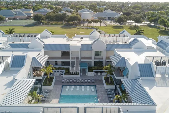 Aerial view of residential area with a pool area with beach in background - quick access to 5th Ave. NEW CONSTRUCTION AND NEVER LIVED IN CONDO