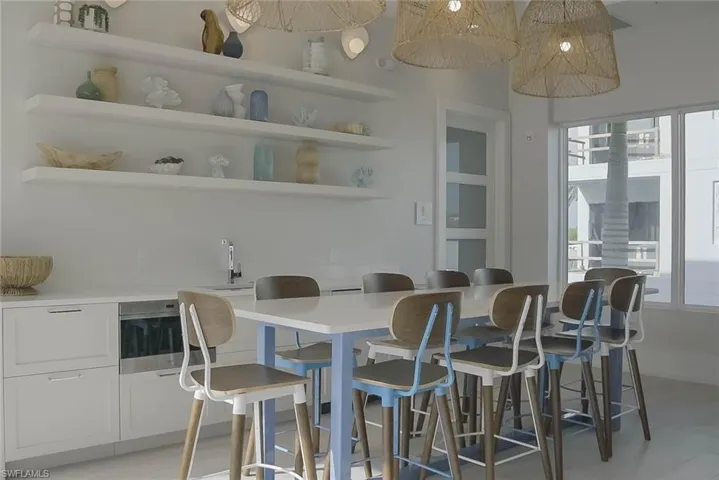 Recreation room with golf simulator and bathrooms that lead to the sauna