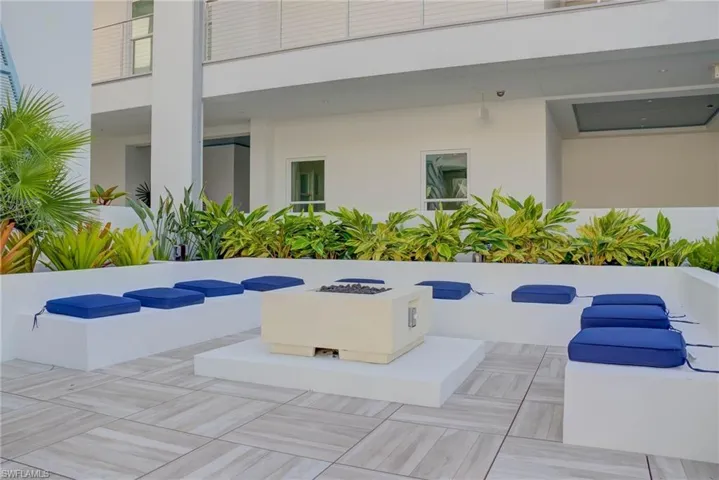 Community pool and hot tub are next to the fire pit area with grilling area on the other side
