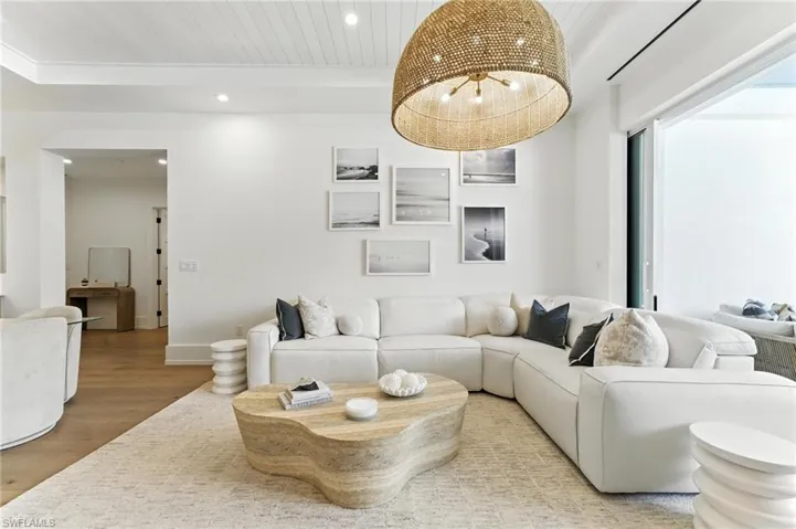 Living room with light wood finished floors, recessed lighting, and wood ceiling