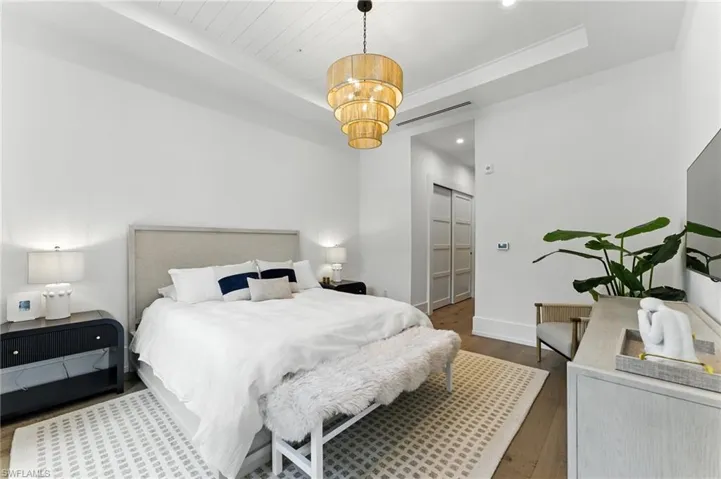Bedroom features a king bed, walkout to patio area, two closets, and en-suite primary bathroom