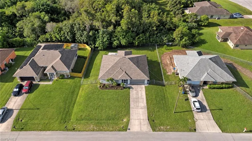Single-story residence with a gray shingle roof, attached garage, and concrete driveway