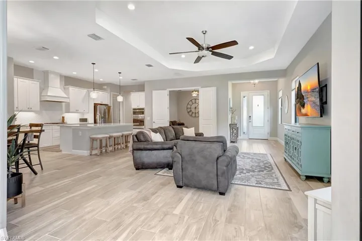 Open concept living room with adjacent den
