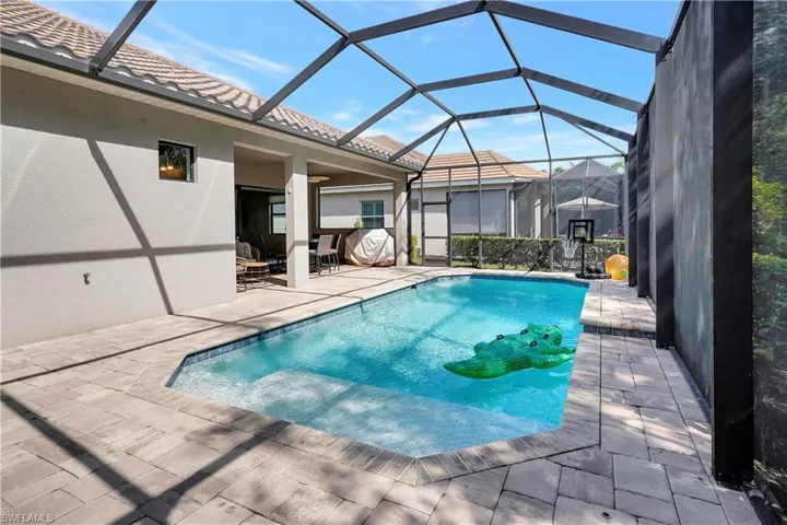 Outdoor heated pool with a patio area and a lanai that is fully stubbed for water and natural gas, ready for your custom outdoor kitchen
