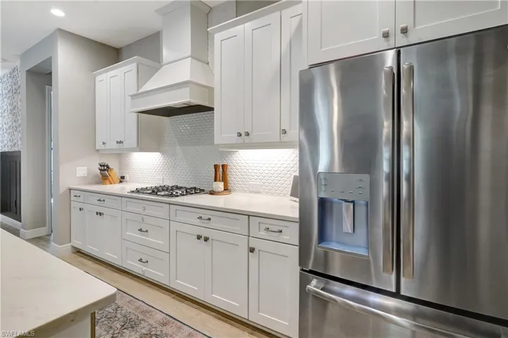 Gourmet kitchen featuring upgraded range and overhead exhaust hood