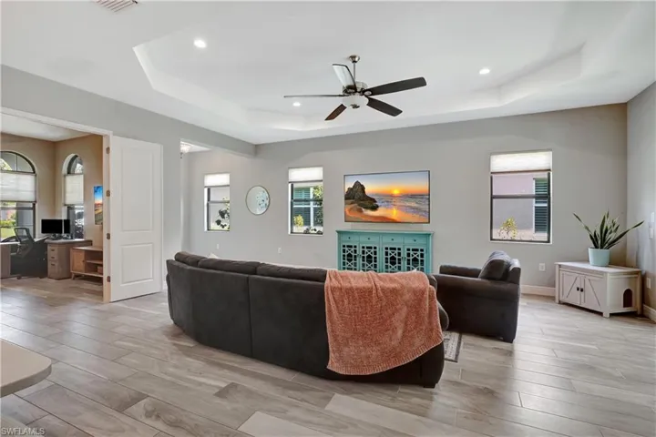 Open concept living room with den/adjacent