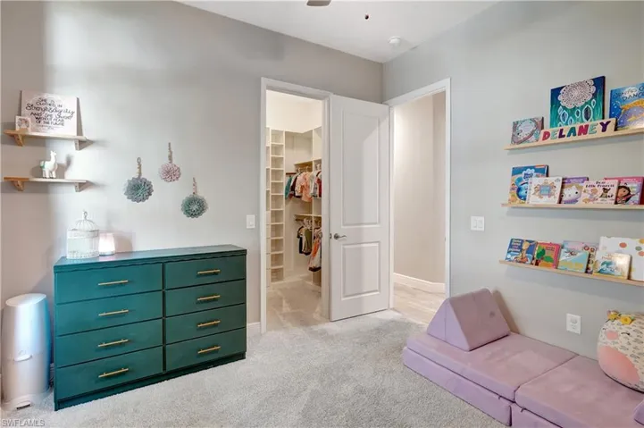 Third bedroom featuring carpet flooring, a ceiling fan, and baseboards