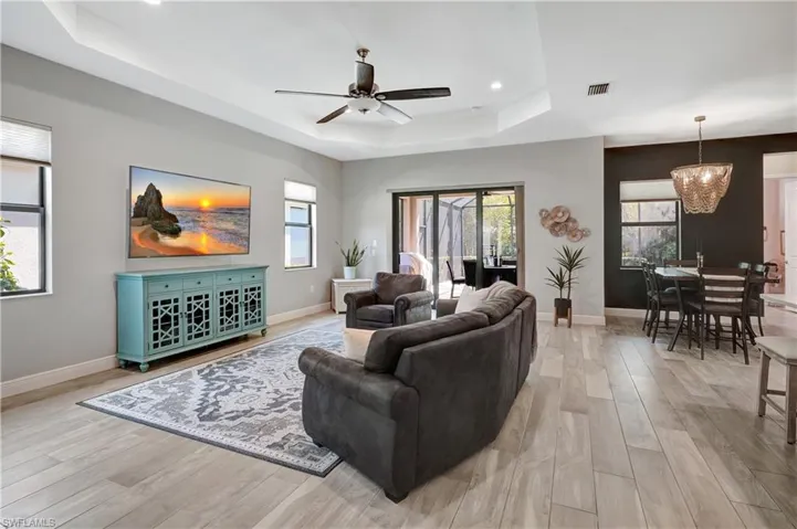 Open concept living room open to patio with built in pool