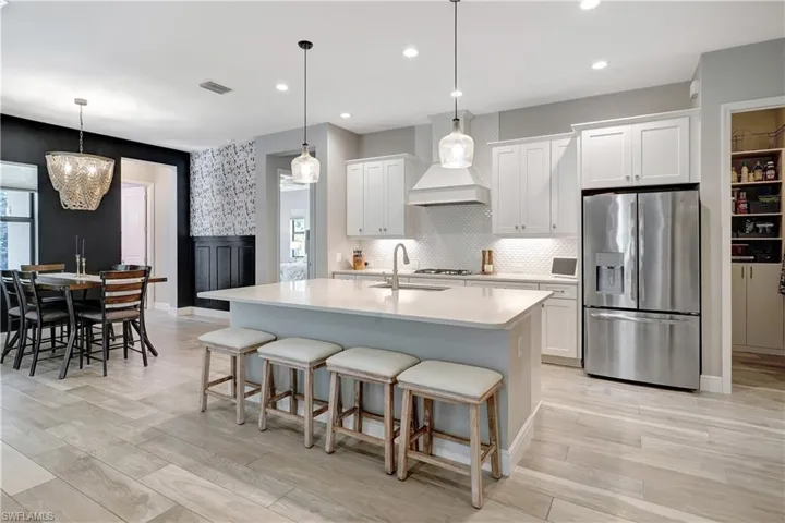 Kitchen featuring quartz countertops, upgraded stainless steel appliances and natural gas stovetop