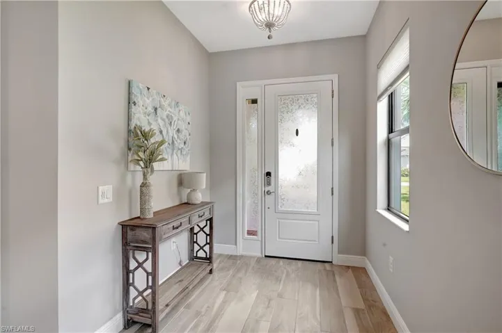 Entryway with light wood-look style flooring