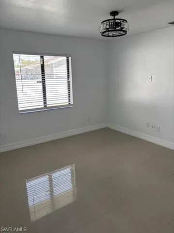 Unfurnished room featuring baseboards