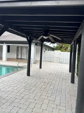 View of patio / terrace with a pergola, ceiling fan, a gate, and an outdoor pool