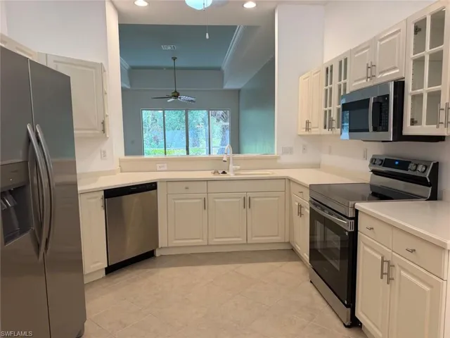 Newly renovated kitchen with new appliances and new glass cabinet doors