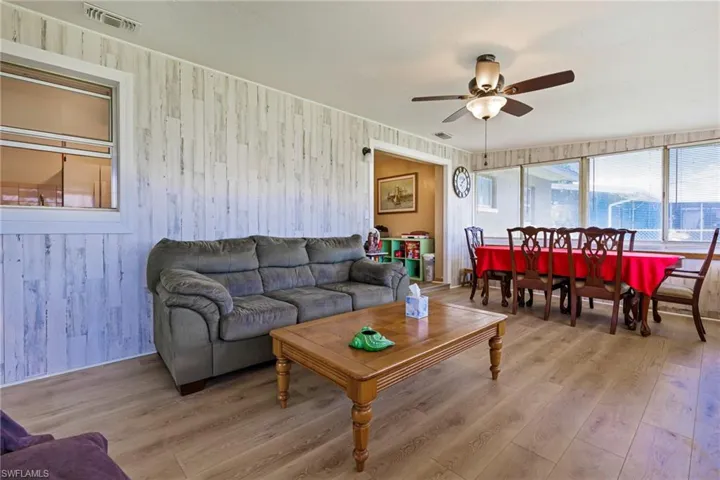Living room with hardwood / wood-style floors and ceiling fan