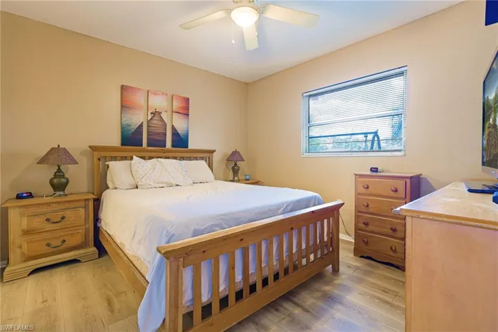 Bedroom featuring wood-type flooring and ceiling fan