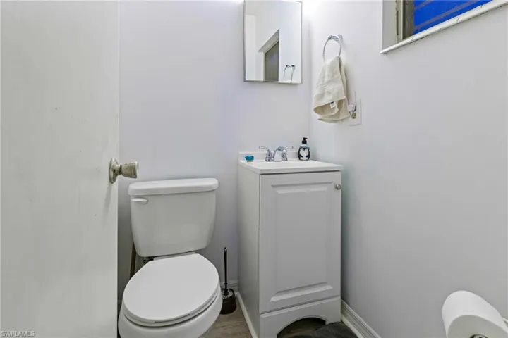 Bathroom featuring vanity, toilet, and hardwood / wood-style flooring