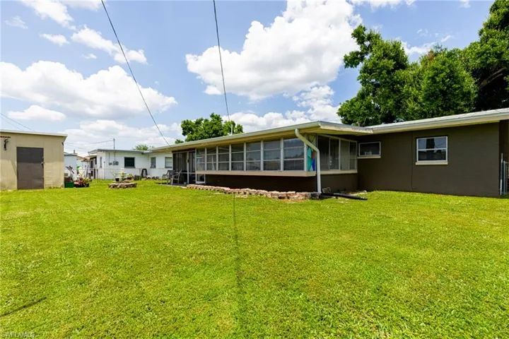 View of yard featuring a sunroom