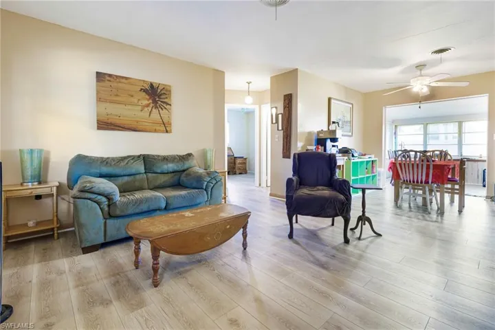 Living room with ceiling fan and hardwood / wood-style floors