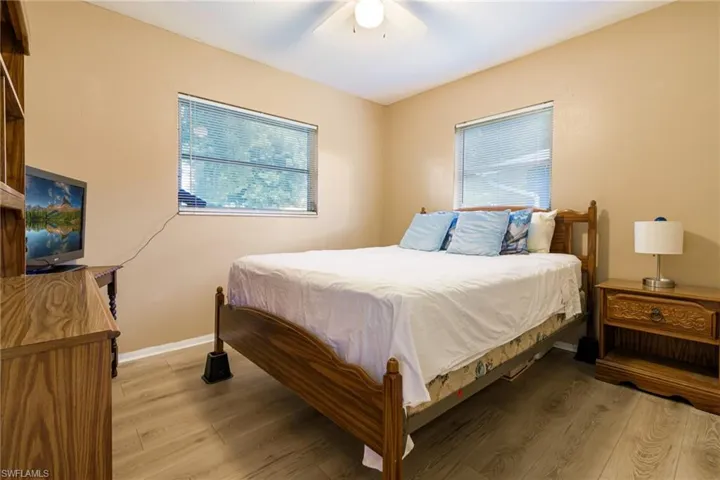 Bedroom featuring wood-type flooring and ceiling fan