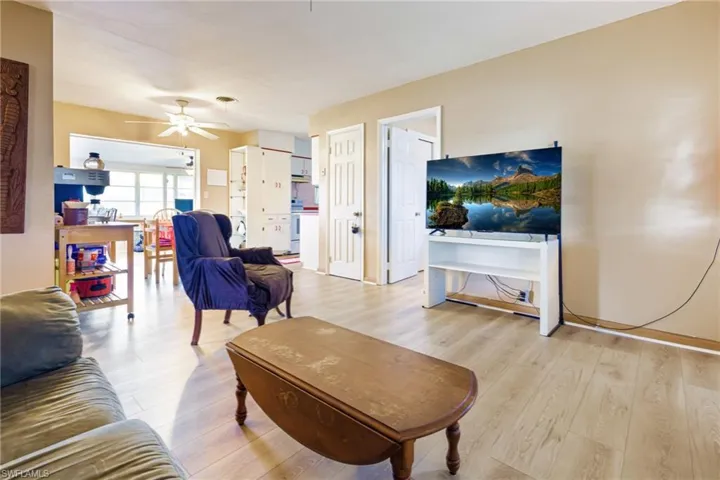Living room with ceiling fan and light wood-type flooring