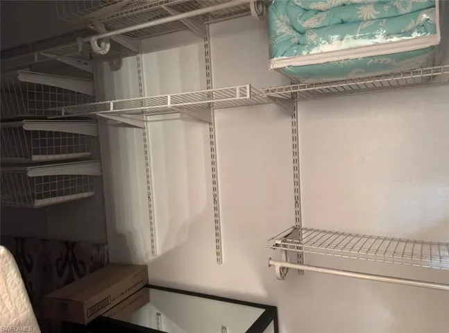 Adjustable wire shelving system with integrated hanging rods and pull-out wire baskets