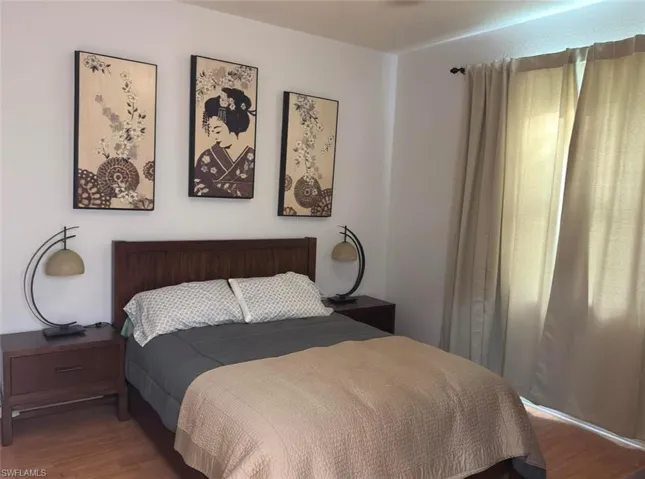 Wood-finish flooring, wood headboard, and wood nightstands