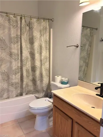 Built-in vanity with wood-finish cabinetry, integrated sink, and dark-finish faucet