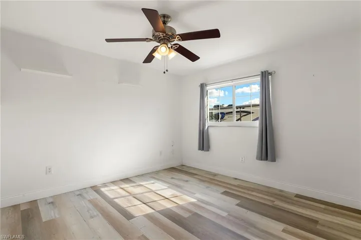 Spare room with ceiling fan and light hardwood / wood-style floors